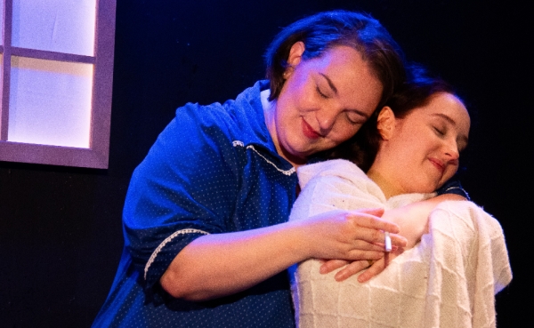 Tatiana Pavela as Carol (left) in a moment of happiness with her daughter, the young Anna played by Laila Malak, in "Anatomy of a Suicide" at RedTwist Theatre through August 30, 2026.