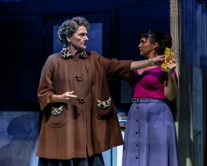 Margaret Sanger (Janet Ulrich Brooks, left) and Ramona Delgado (María Victoria Martínez, right) scuffle over a copy of "The Birth of the Pill."