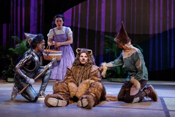David Omari as Tin Man, Nora Wragg as Dorothy Gale, Jake Elkins as Cowardly Lion, and Ben Woods as Scarecrow in Metropolis Performing Arts Centre's The Wizard of Oz.